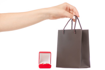 Female hand holding a box for jewelry earrings and a package
