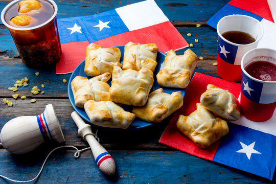 Chilean independence day concept. fiestas patrias. Chilean typical dish and drink on independence day party, 18 september. Mini empanadas, mote con huesillo, wine with toasted flour, chicha and