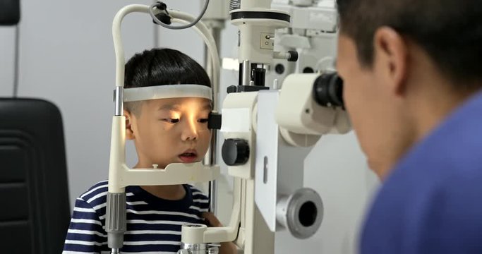 Little boy doing eye test optical clinic