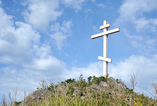 Orthodox Cross at the Top of the Hill with Dramatic sky on Background