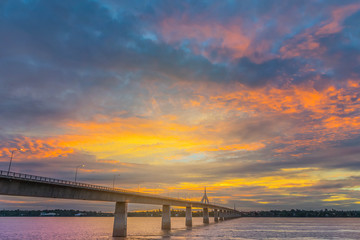 Fototapeta premium Abstract soft blurred and soft focus silhouette sunrise with the beautiful sky in the morning at Thailand, Laos friendship bridge with the beam light and lens flare effect tone.
