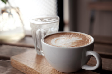A cup of coffee put on wooden board