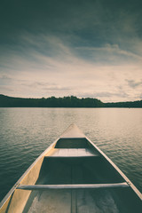 Aluminum canoe on a mountain lake upstate New York. Camping. outdoors and adventure concept. ...