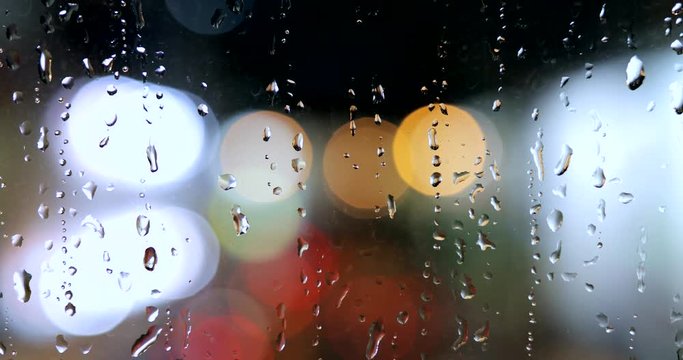 Rain drop on window glass at night
