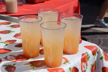 Lemonade stand with drinks of cantaloupe ade ready to serve at farmer's market lemonade stand