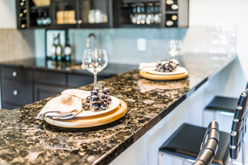 Grapes on plate of modern granite kitchen bar in luxury apartment or restaurant