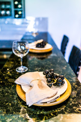 Grapes on plate of modern granite kitchen bar in luxury apartment or restaurant