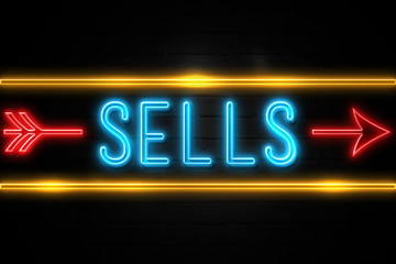 Sells  - fluorescent Neon Sign on brickwall Front view