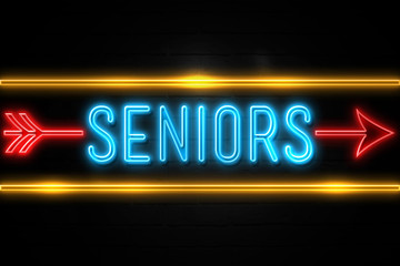 Seniors  - fluorescent Neon Sign on brickwall Front view