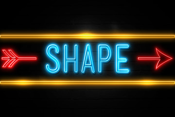 Shape  - fluorescent Neon Sign on brickwall Front view