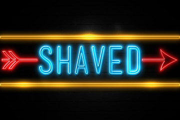 Shaved  - fluorescent Neon Sign on brickwall Front view