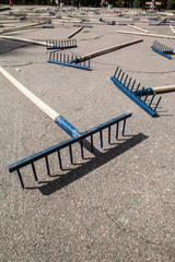 The rake spread out on the sidewalk