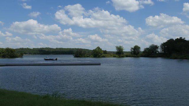 Lake of the Arbuckles with an unrecognizable boater in the background
