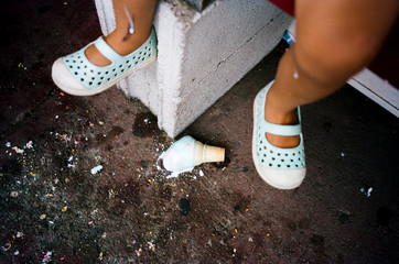 little kid drops ice cream cone with shoes on wrong feet