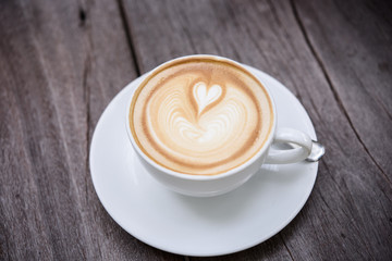 coffee latte art on wood table top view.