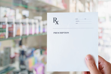 Pharmacist hold blank prescription in pharmacy store - obrazy, fototapety, plakaty