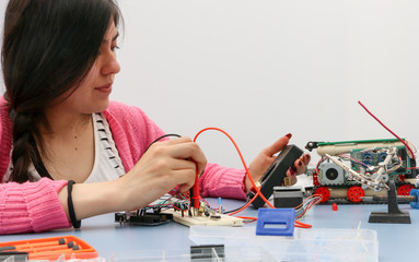 Young electronics student learning about basic PCB connection and robotics