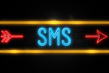 Sms  - fluorescent Neon Sign on brickwall Front view