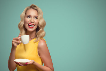 Pop art portrait of beautiful woman drinking coffee on blue background.