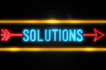 Solutions  - fluorescent Neon Sign on brickwall Front view