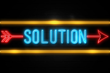 Solution  - fluorescent Neon Sign on brickwall Front view