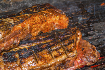 Obraz na płótnie Canvas pork ribs marinated grilling on hot burning charcoal barbecue close-up