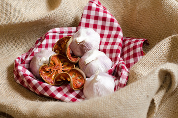 Fototapeta na wymiar Garlic put on red scott cover by vintage burlap.