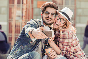 Young couple taking selfie in the city.