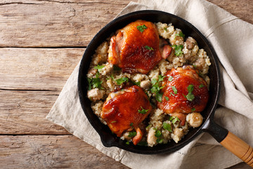 Natural Food: Baked chicken thighs with quinoa and mushrooms close up. horizontal top view