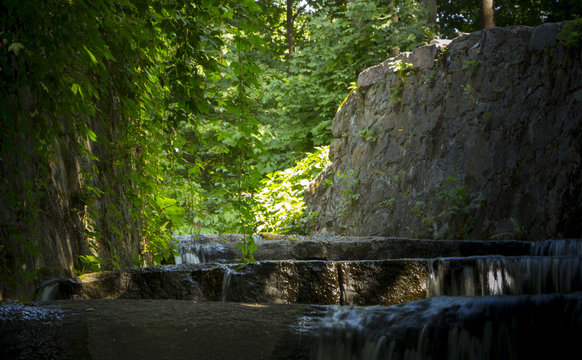 Decorative waterfall with rapids and overflows in the forest