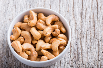 Roasted cashew nuts on rustic wood