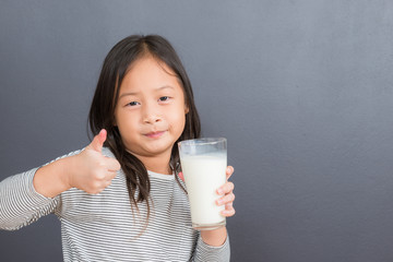 Asian kid cute girl  happy to drink milk