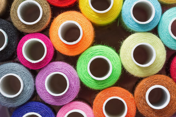 A lot of colorful sewing threads. Abstract background. Top view, closeup.