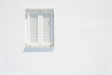 White wall and window with white shutters.