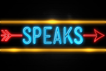 Naklejka na ściany i meble Speaks - fluorescent Neon Sign on brickwall Front view