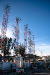 Metal structure designed to light fireworks being built in the center of a plaza in preparation for religious celebrations