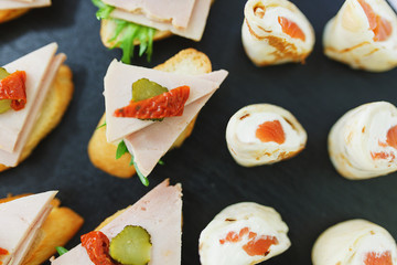 Tapas, canaps, sandwiches, rolls with red fish prepared for the visitors of the event. 
