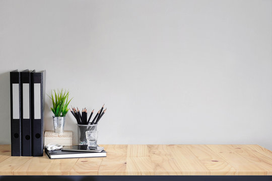 Work space Mock up white tabletop with files, pencils and houseplant. wood desk with copy space for products display montage.
