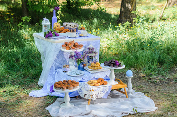 the tables with the desserts . decorated plates of cookies , biscuits. A wedding Banquet . Extra pounds and calories . Sweets of various kinds