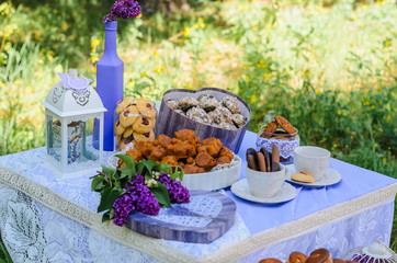 the tables with the desserts . decorated plates of cookies , biscuits. A wedding Banquet . Extra pounds and calories . Sweets of various kinds