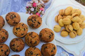 the tables with the desserts . decorated plates of cookies , biscuits. A wedding Banquet . Extra pounds and calories . Sweets of various kinds