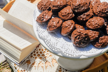 the tables with the desserts . decorated plates of cookies , biscuits. A wedding Banquet . Extra pounds and calories . Sweets of various kinds