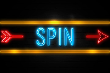 Spin  - fluorescent Neon Sign on brickwall Front view