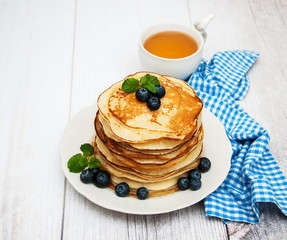 Plate with pancakes and blueberries