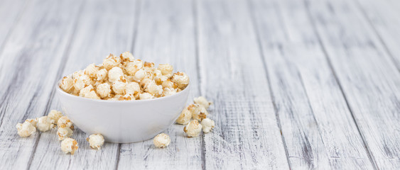 Portion of Popcorn on wooden background, selective focus