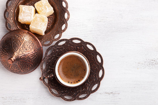 Fototapeta Traditional turkish coffee and turkish delight on white shabby wooden background. flat lay