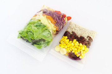 Fresh Salad packed in plastic bag on white background - Fast healthy food concept