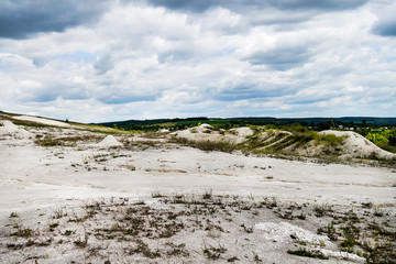 Quarry for the extraction of sand and a beautiful sky in the clouds above it