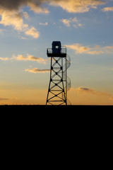 military surveillance tower at sunset