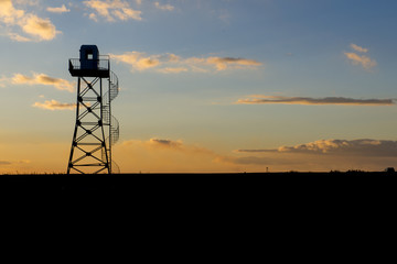 military surveillance tower at sunset